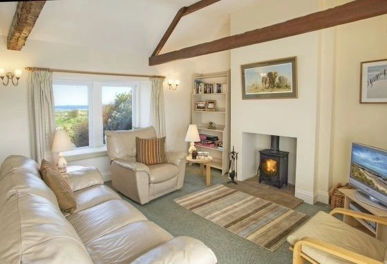 Sunlit living room with wood burner